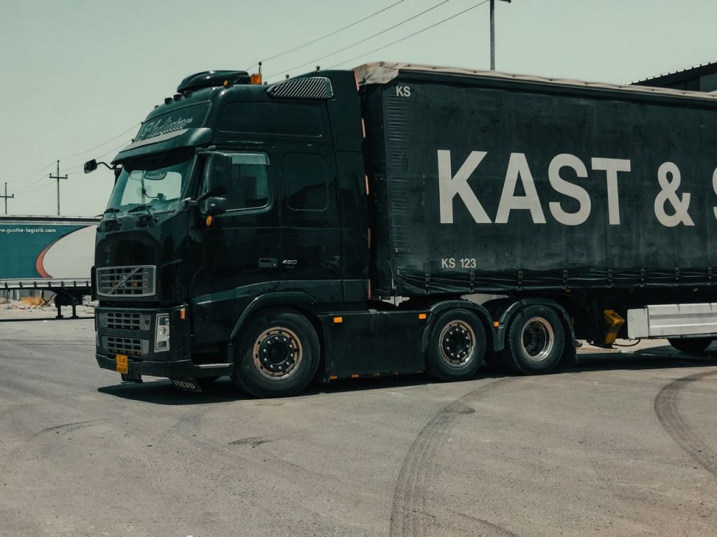A large industrial truck parked in an urban setting, showcasing transportation industry visuals.